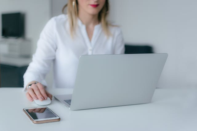 person in a white shirt working on their computer